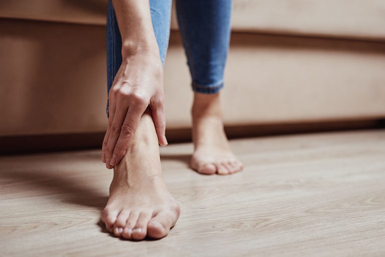 Woman have pain in leg, take ankle massage
